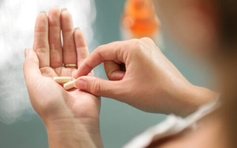 Hand holding vitamins