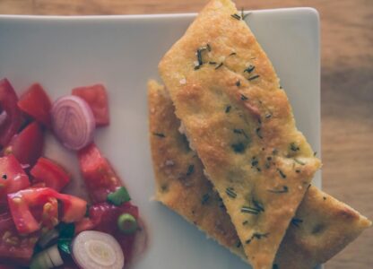 Roasted Veggie Focaccia Layered with Eggplant, Roasted Peppers, Portabello Mushrooms, Feta Cheese, Arugula, and Garlic Balsamic Vinaigrette
