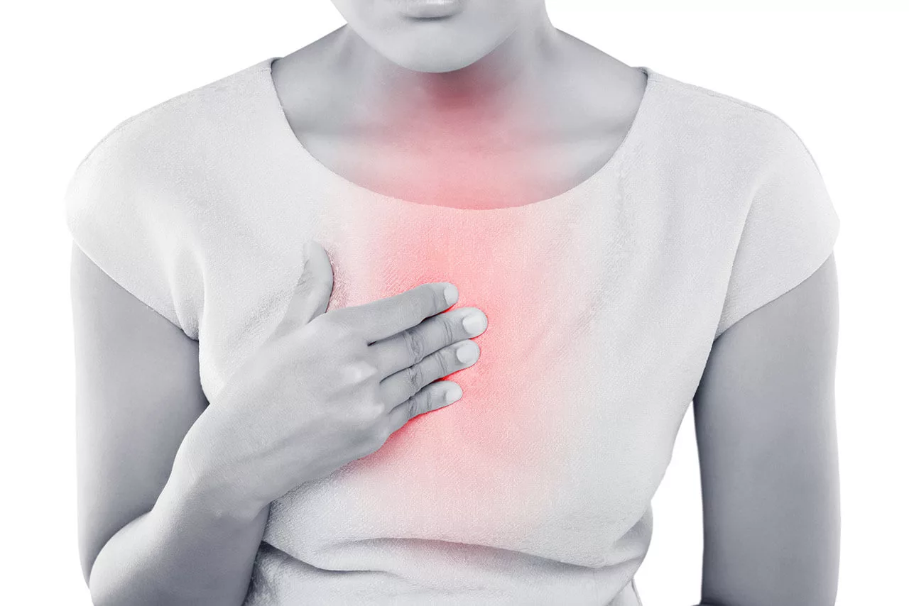 Woman experiencing heartburn