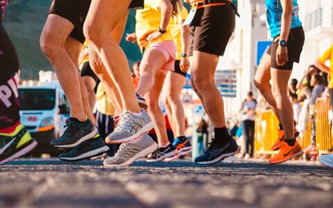Shoes of a group of people that are about to run a marathon