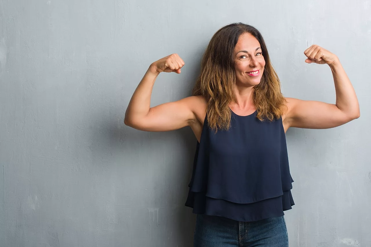 Woman smiling and flexing arms