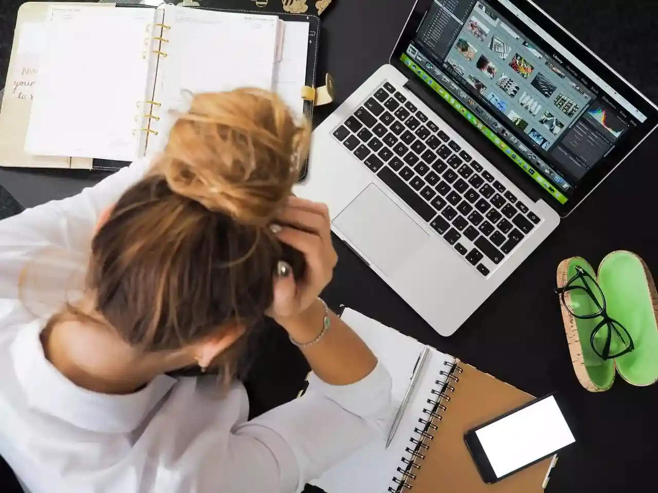 woman appearing stressed in front of computer