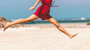woman jumping at the beach