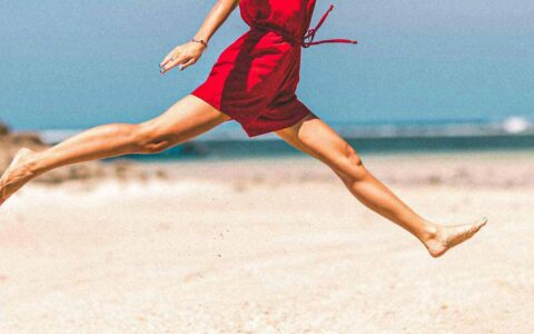 woman jumping at the beach