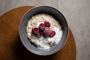 bowl of oats with chia seeds and raspberries