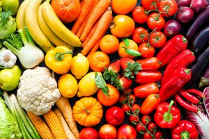 An assortment of produce is laid out in a rainbow color scheme.