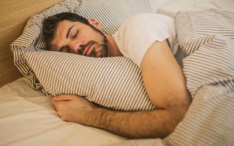 man sleeping in his bed