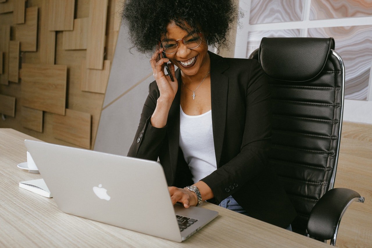 Woman on the phone sitting in front of her computer