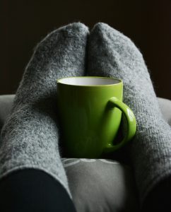 green mug and fuzzy socks
