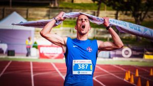 Man crossing the finish line in a marathon