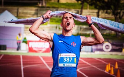Man crossing the finish line in a marathon
