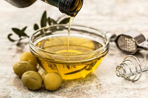 olive oil being poured into bowl