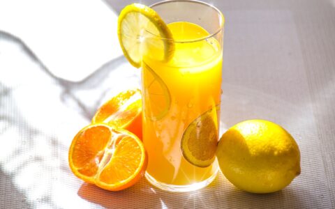 glass of orange juice with a slice of lemon