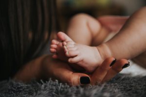 baby's feet in mom's hands