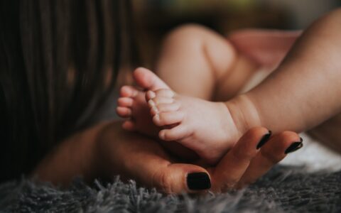 baby's feet in mom's hands
