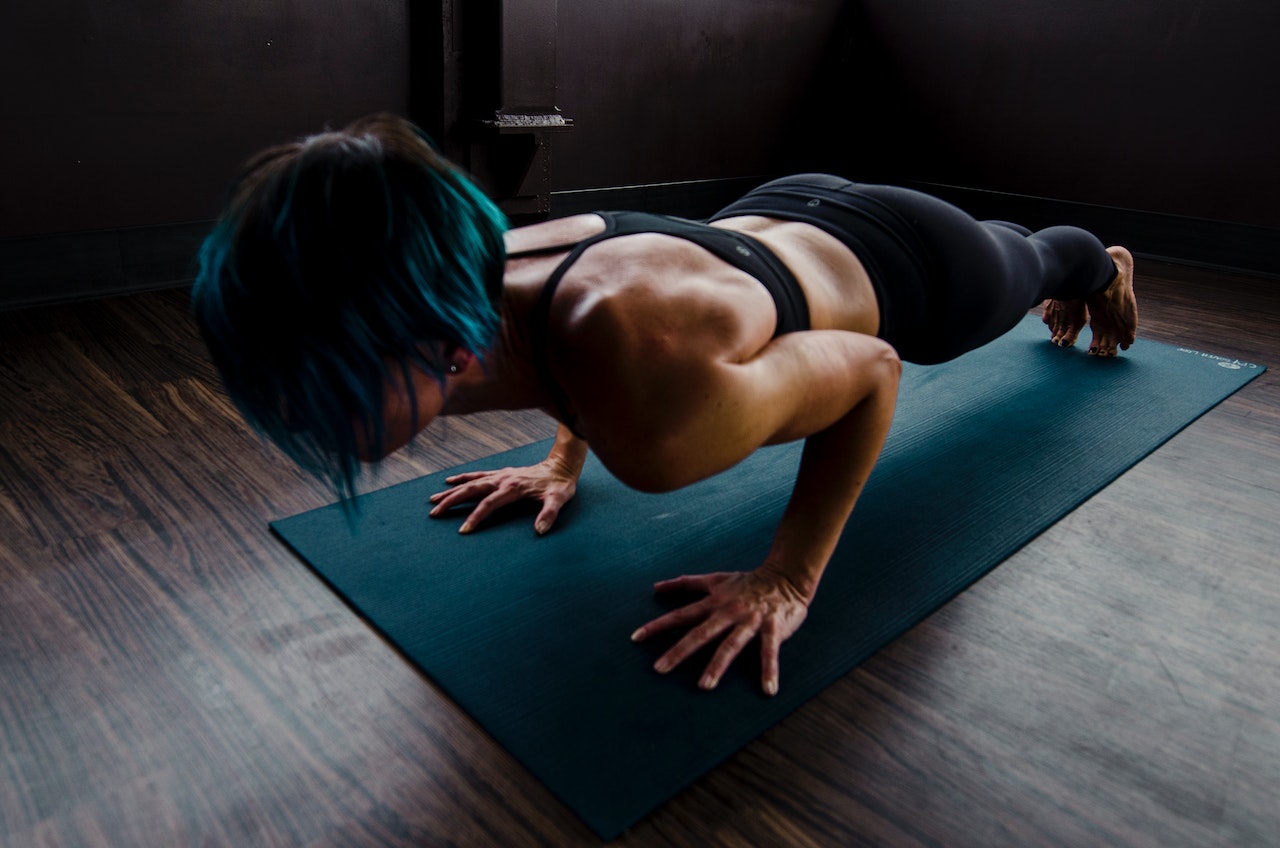 woman doing a plank on a mat