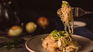 sauerkraut topped with green onions on a plate