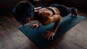 woman doing a push up on a mat