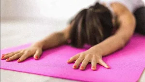 woman stretching on yoga mat