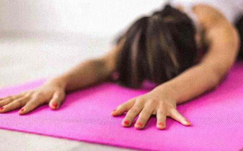 woman stretching on yoga mat