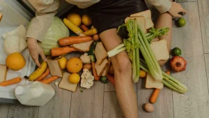 someone sitting with vegetables spread out