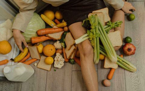 woman sitting with vegetables