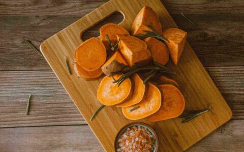 sliced sweet potatoes on a cutting board