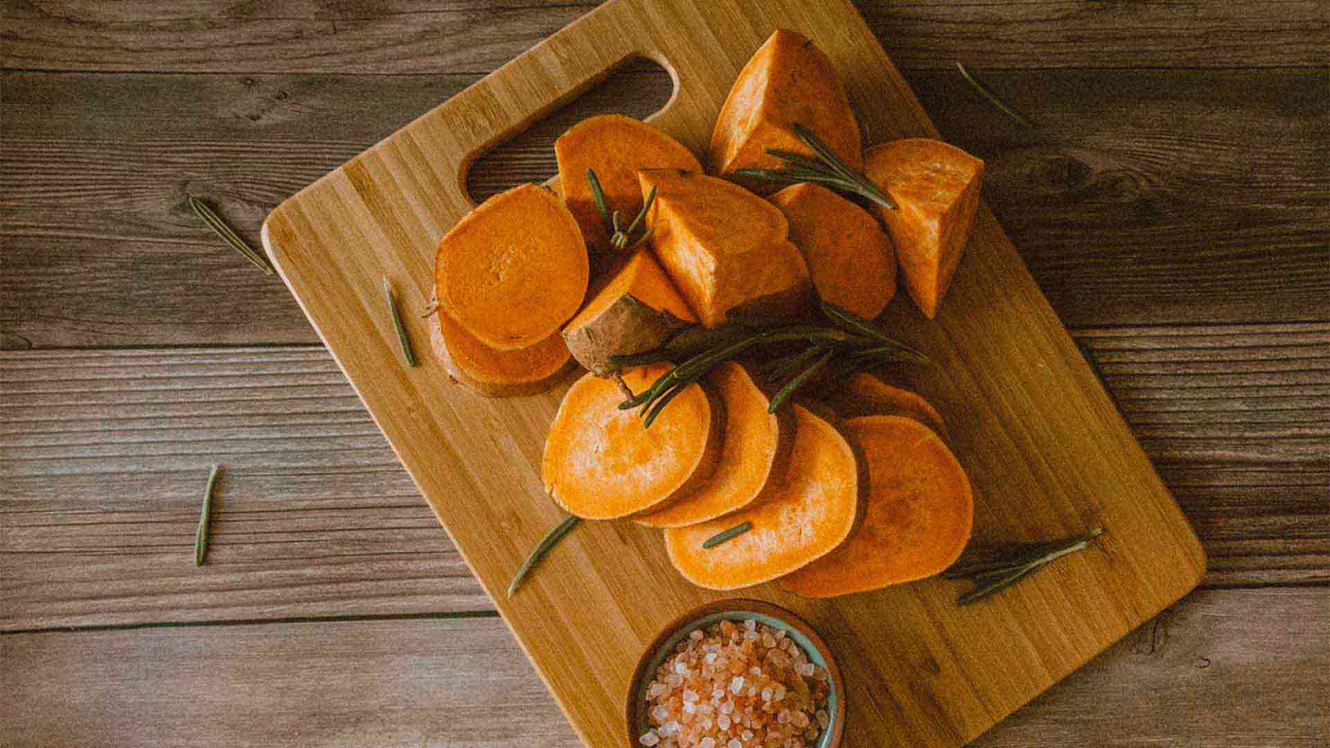 sliced sweet potatoes on a cutting board