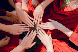 circle of hands showing off nails