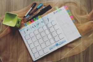 a calendar planner with colorful pends