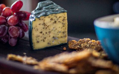 cheese wedge with grapes