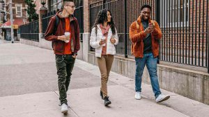 three people walking together outside