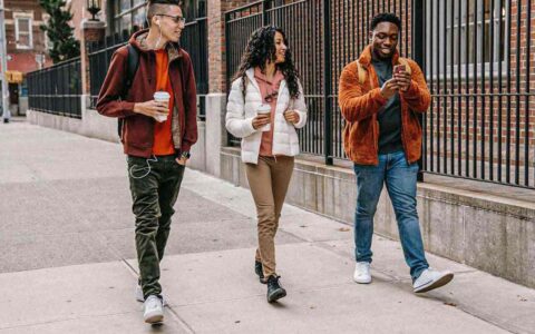 three people walking together outside