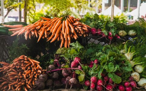 market with different vegetables like carrots, beets and radish