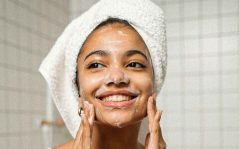 woman washing her face