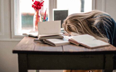 woman sleeping at her desk