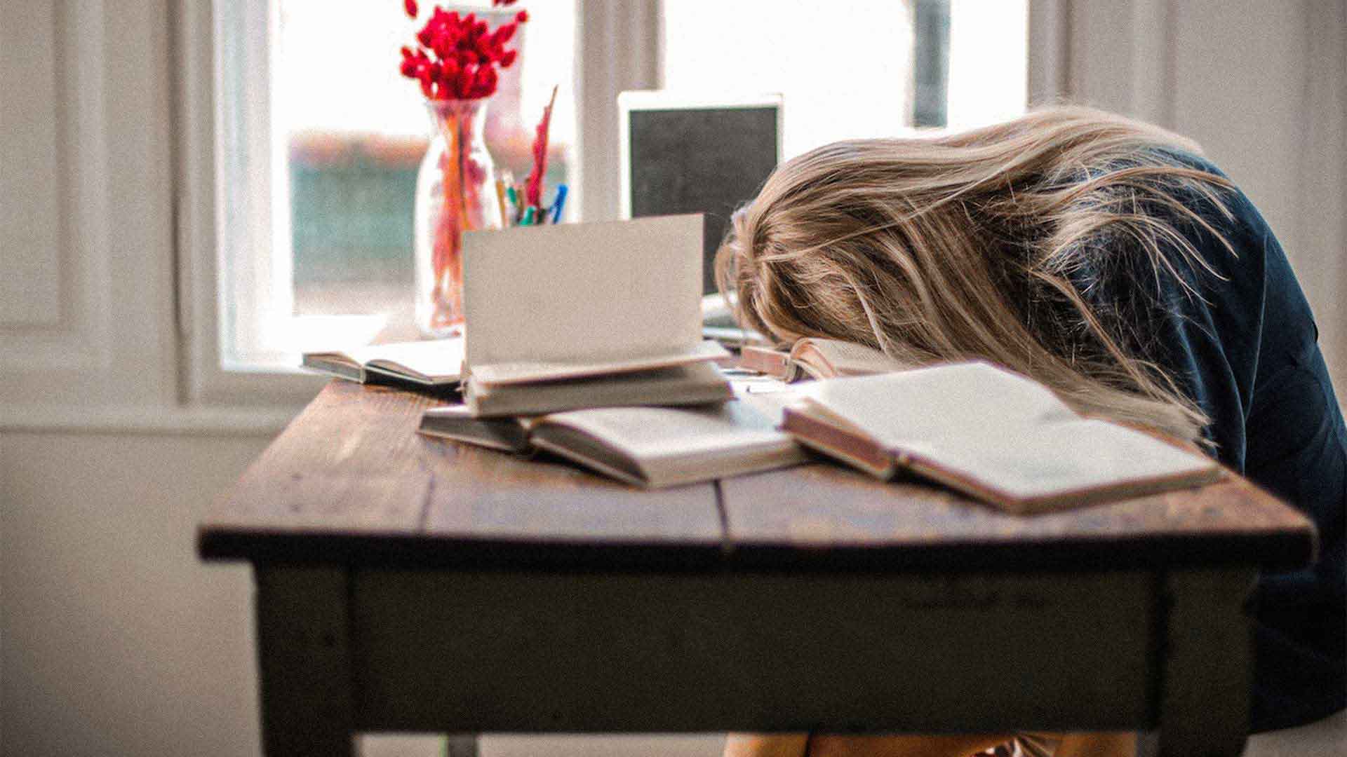 woman sleeping at her desk