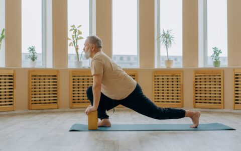Man stretching with wooden blocks for joint flexibility and mobility