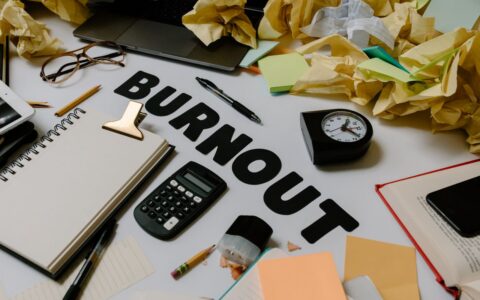 Cluttered work desk showing how a busy schedule can make staying consistent with healthy habits more challenging.