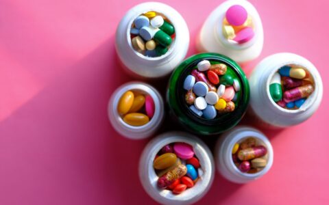 Personalized vitamins vs. multivitamin: individual supplement pills in containers