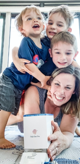 Mom with her three kids holding a Persona vitamin box